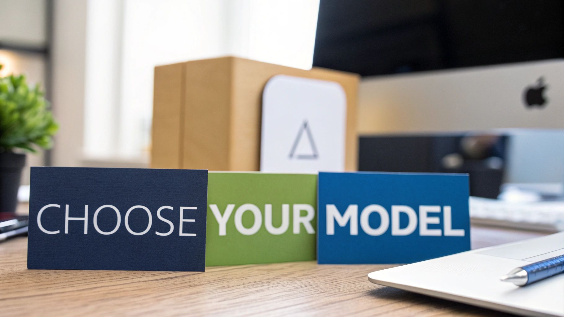 Three cards displaying 'CHOOSE YOUR MODEL' on a wooden desk in an office setting.